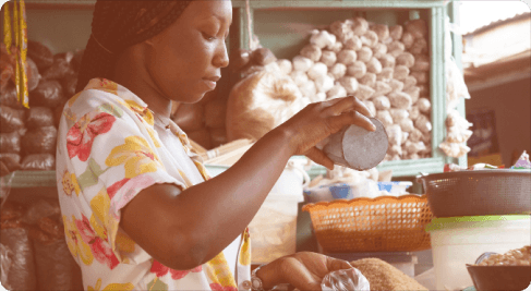 A market researcher examining goods at a local market